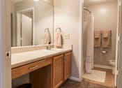 Thumbnail 13 of 33 - A bathroom with a white sink and a mirror.