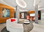 Thumbnail 13 of 40 - A modern living room with a white sofa and a large abstract painting on the wall.