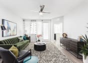 Thumbnail 25 of 44 - Spacious living room with large windows and natural lighting at Residences at The Green in Lakewood Ranch