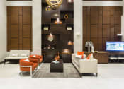 Thumbnail 23 of 42 - Resident lounge with couch and chairs  at LandonHouse Apartments in Lake Nona, Orlando, FL 32827