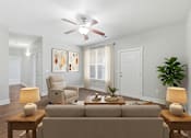 Thumbnail 5 of 15 - A living room with a beige couch, a chair, a ceiling fan, and two lamps.