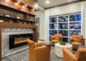 Thumbnail 28 of 42 - Fireplace and seating by pool window in resident lounge  at LandonHouse in Lake Nona