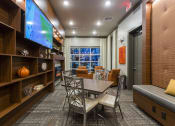 Thumbnail 29 of 42 - Lounge with tables chairs and tv  at LandonHouse in Lake Nona