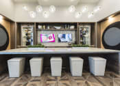 Thumbnail 5 of 44 - Lounge with tvs and bar top with padded stools at Residences at The Green in Lakewood Ranch, FL