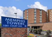Thumbnail 25 of 28 - a sign for memphis towers in front of a brick building