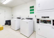 Thumbnail 11 of 12 - Laundry room with washers and dryers and shelf for folding