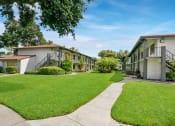 Thumbnail 12 of 32 - Lush Green Outdoors at The Oasis Apartments, Daytona Beach, FL