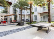 Thumbnail 8 of 42 - Outdoor Recreation Area with ping-pong tables at LandonHouse Apartments in Lake Nona, Orlando, FL 32827