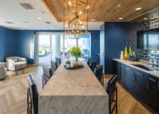 Thumbnail 19 of 42 - Indoor lounge with seating kitchenette and access to outdoor dining room at Lake Nona Pixon, Florida