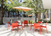 Thumbnail 6 of 42 - Outdoor picnic area with large umbrellas