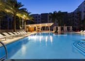 Thumbnail 39 of 42 - Illuminated pool at twilight with palm trees  at LandonHouse in Lake Nona
