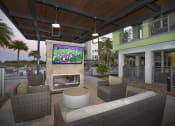 Thumbnail 22 of 44 - Outdoor TV and fireplace lounge poolside at The Residences at The Green in Lakewood Ranch, Florida