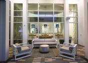 Thumbnail 9 of 44 - Sitting area with chairs and couch outside of the game lounge at Residences at The Green