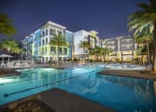 Thumbnail 2 of 44 - Luxury, resort-style, olympic-sized pool at night at Residences at The Green Apartments for rent