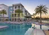 Thumbnail 17 of 44 - Olympic-sized pool surrounded by palms, lounges, and residences at Residences at The Green