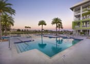 Thumbnail 18 of 44 - The large, tranquil pool at Residences at The Green at dusk