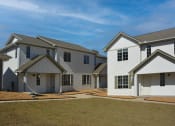 Thumbnail 19 of 48 - a row of newly built houses with green grass and neat sidewalks at The Sanctuary at Indian Creek