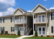 Thumbnail 4 of 18 - beautiful apartment exterior with well-kept landscaping and sidewalk
