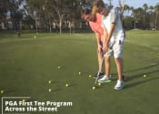 Thumbnail 5 of 57 - a pga first tee tee program across the street with two girls playing golf