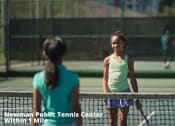 Thumbnail 40 of 57 - two young women playing tennis on a tennis court
