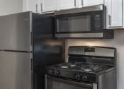 Thumbnail 21 of 32 - Stainless Steel appliance package with range, fridge and mounted microwave at Terraces at Clearwater Beach, Florida
