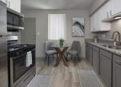 Thumbnail 20 of 32 - Kitchen with granite countertops, stainless steel appliances, and wood-style floors at Terraces at Clearwater Beach, Clearwater, 33756