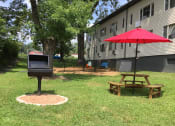 Thumbnail 23 of 24 - grilling and shaded picnic table by the dog park at The Flats at Jackson Square