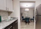 Thumbnail 9 of 19 - Kitchen with granite countertops and stainless steel appliances at The Madison Franklin, Tennessee, 37064