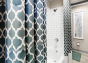 Thumbnail 14 of 19 - Bathroom with tile surround tub/shower at The Madison Franklin, TN