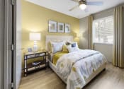 Thumbnail 15 of 19 - Bedroom with ceiling fan, large window, and plank-style flooring at The Madison Franklin, Tennessee, 37064
