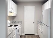 Thumbnail 2 of 8 - The Bluffs Apartments in-home kitchen with white appliances, cabinets, and wood-style flooring