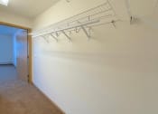 Thumbnail 19 of 24 - a large walk-in closet with built-in wire shelving in an Algonquin Manor Apartment home