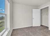 Thumbnail 8 of 24 - an empty bedroom with a closet and a window