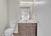 Thumbnail 9 of 24 - a bathroom with a sink toilet and a mirror