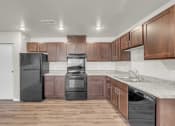 Thumbnail 7 of 24 - a kitchen with wooden cabinets and a black refrigerator