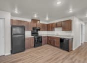 Thumbnail 1 of 24 - a kitchen with wooden cabinets and black appliances