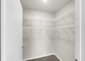 Thumbnail 11 of 24 - the closet of a studio apartment with white walls and mirrored racks