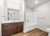 Thumbnail 10 of 24 - a bathroom with a toilet and a sink and a mirror