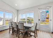 Thumbnail 16 of 24 - a dining room with a table and chairs and large windows