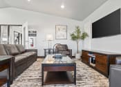 Thumbnail 13 of 24 - a living room with couches a coffee table and a television