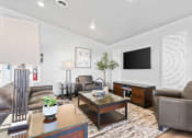 Thumbnail 14 of 24 - a living room with leather furniture and a television