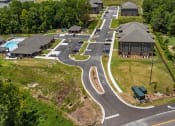 Thumbnail 34 of 57 - an aerial view of a neighborhood with houses and a road