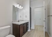 Thumbnail 37 of 57 - a bathroom with a sink and a toilet and a mirror