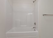 Thumbnail 32 of 57 - a white bathroom with a shower and a sink