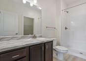 Thumbnail 28 of 57 - a bathroom with a toilet sink and shower and a mirror
