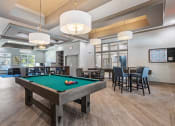 Thumbnail 4 of 57 - a clubhouse with a pool table and dining tables