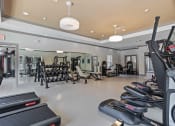 Thumbnail 15 of 57 - a gym with treadmills and other exercise equipment