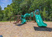 Thumbnail 8 of 57 - a playground with slides at a park with trees