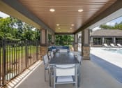 Thumbnail 43 of 57 - a patio with a dining table and chairs next to a pool
