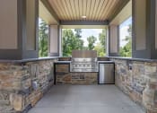 Thumbnail 55 of 57 - the outdoor kitchen is equipped with a grill and a large window